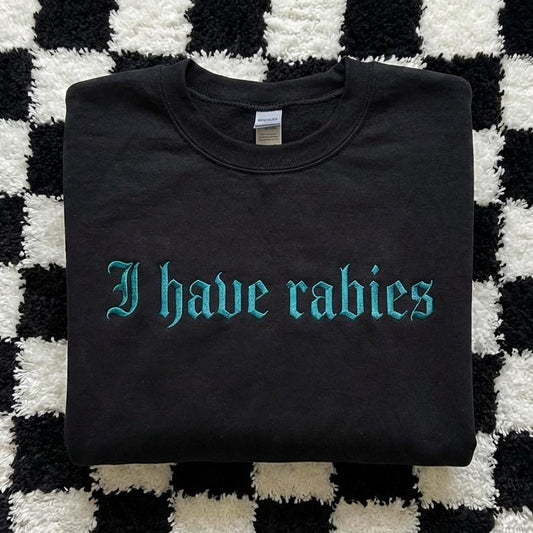 Black sweatshirt with 'I have rabies' text on a checkered background